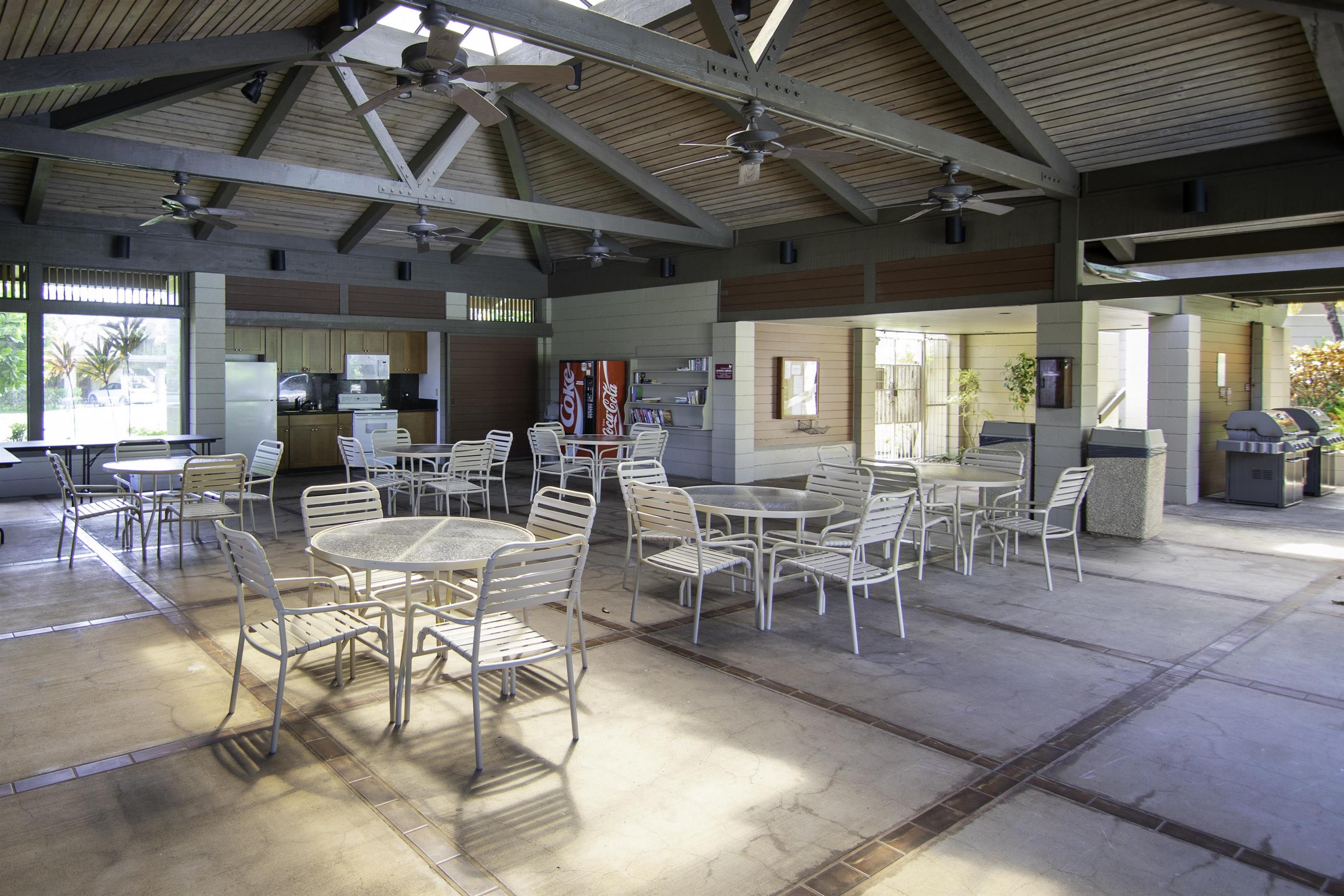 100 Ridge Road, Unit 232324 Lahaina, HI 96761 - Photo 46 of 50 a room with lots of tables a large window and chairs