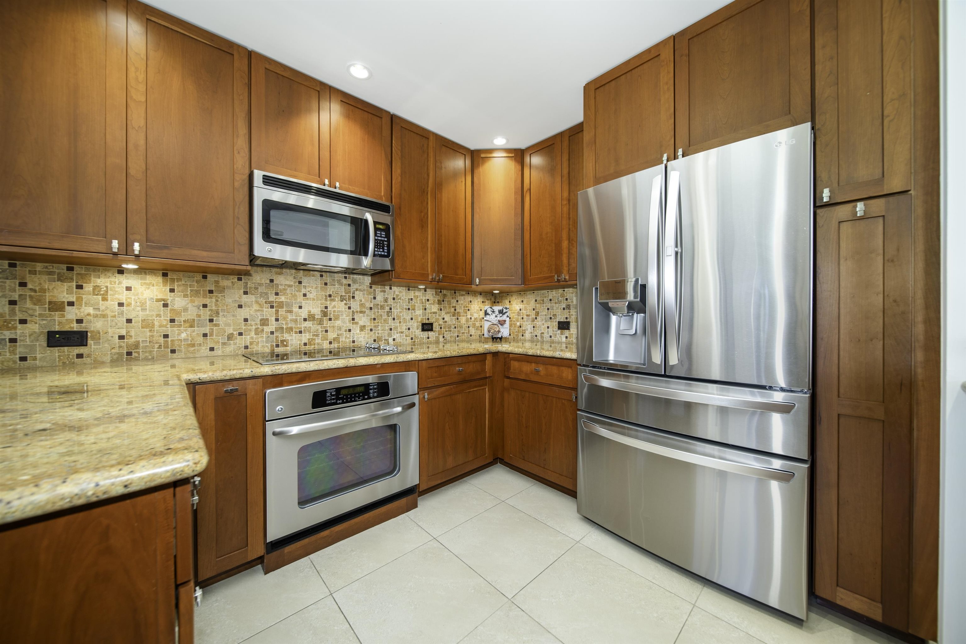 100 Ridge Road, Unit 232324 Lahaina, HI 96761 - Photo 7 of 50 a kitchen with stainless steel appliances granite countertop a refrigerator stove and sink