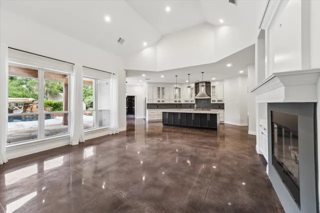 a large kitchen with a large window and stainless steel appliances