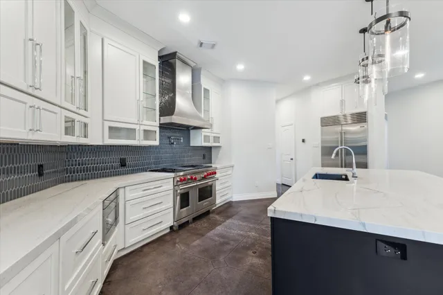 a kitchen with stainless steel appliances a sink stove and refrigerator