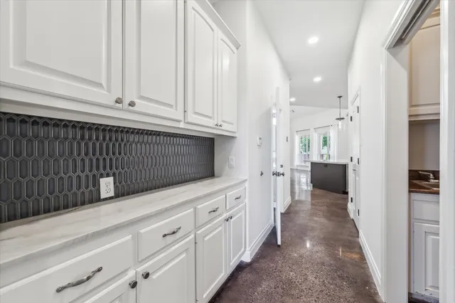 a kitchen with white cabinets and white appliances