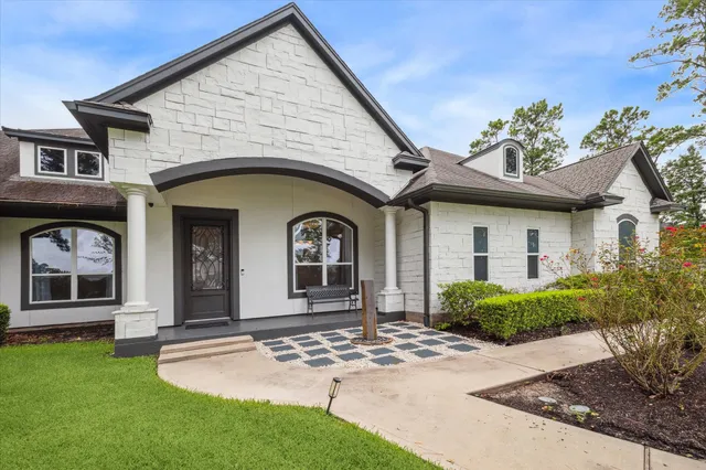 a front view of a house with garden