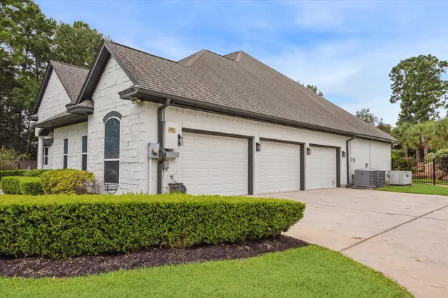 a front view of a house with a garden and plants