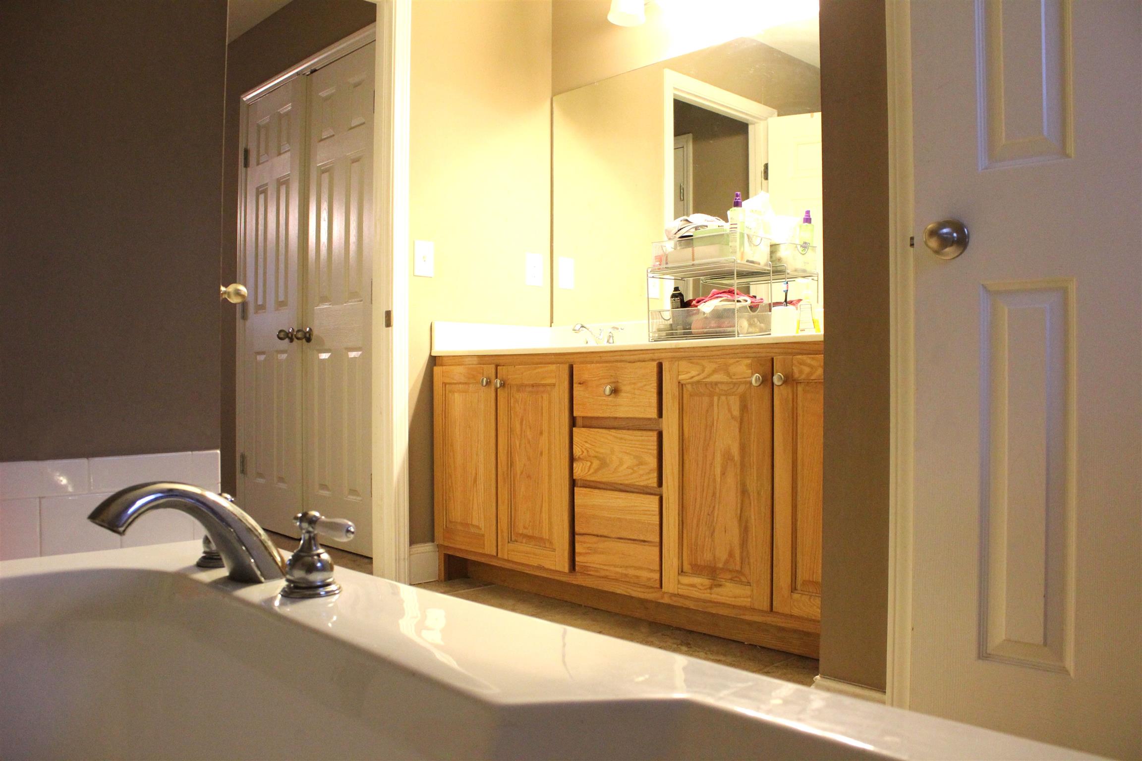 4107 Roy Thompson Road Mount Pleasant, TN 38474 - Photo 7 of 16 His and hers vanity with a separate garden/spa tub and shower in the master bath.