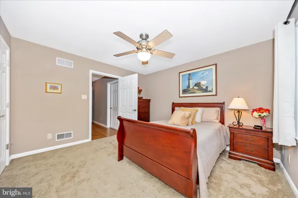 a kitchen with stainless steel appliances a dining table chairs stove and refrigerator
