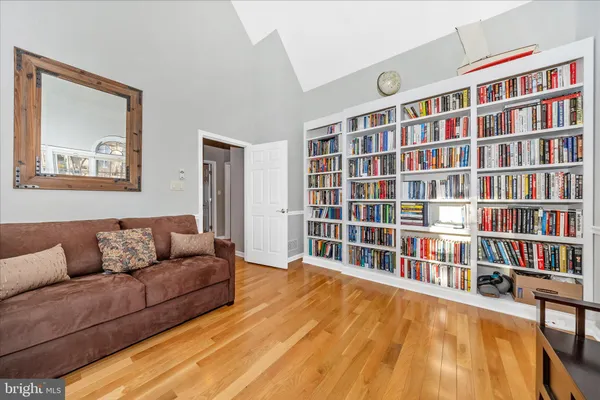 a living room with a couch and a book shelf