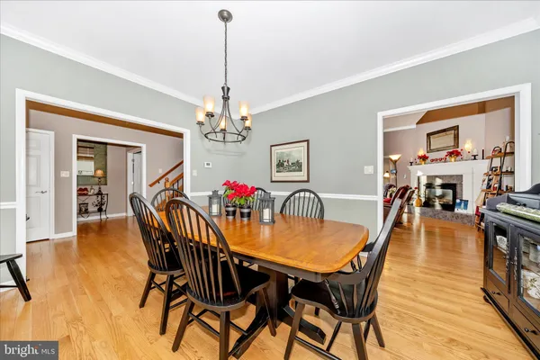 a view of a dining room with furniture wooden floor and a chandelier