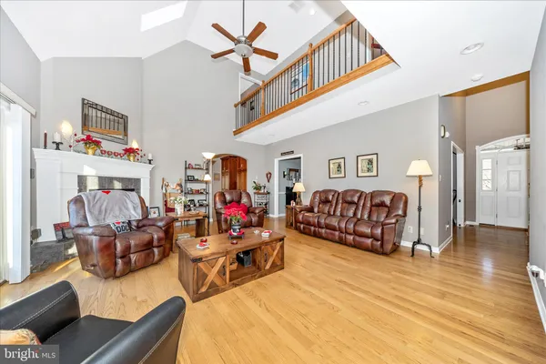 a living room with furniture a couch and dresser with wooden floor