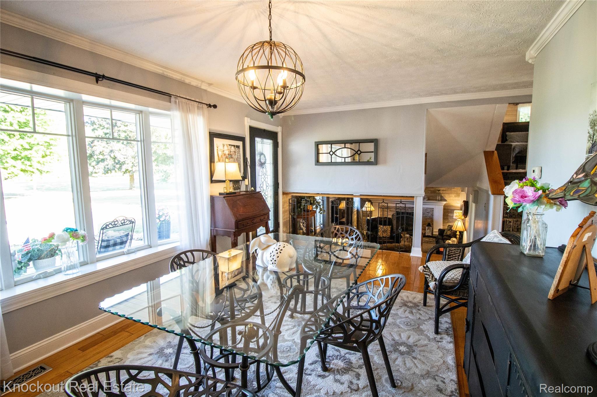 14720 Lincoln Road Chesaning, MI 48616 - Photo 15 of 60 Elegant dining room showcasing a wood-finish table, black Windsor-style chairs, and hardwood flooring