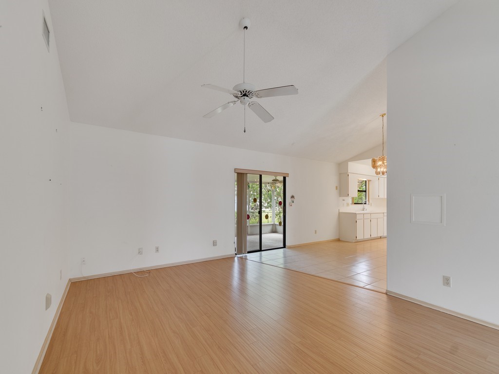 717 Doctor Avenue Sebastian, FL 32958 - Photo 13 of 33 an empty room with wooden floor ceiling fan and windows