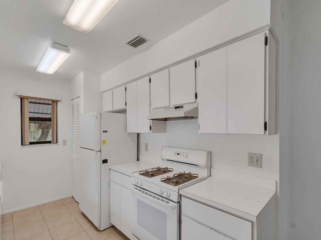 717 Doctor Avenue Sebastian, FL 32958 - Photo 16 of 33 a kitchen with stainless steel appliances white cabinets and a stove