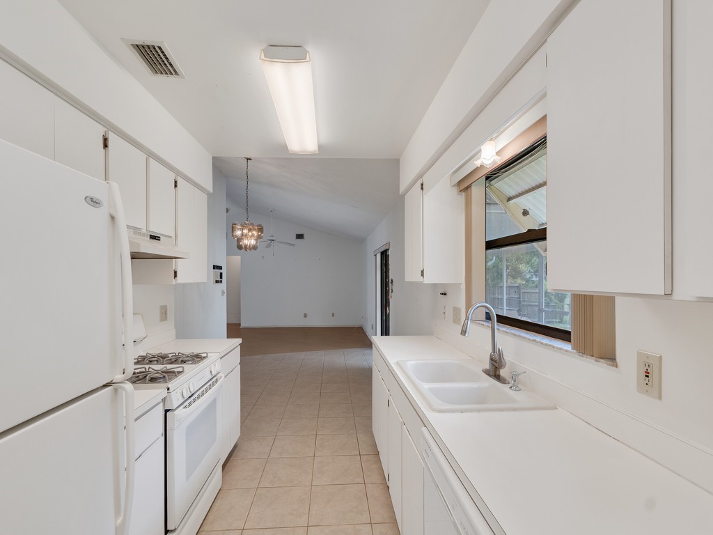 717 Doctor Avenue Sebastian, FL 32958 - Photo 18 of 33 a large white kitchen with a sink and washing machine