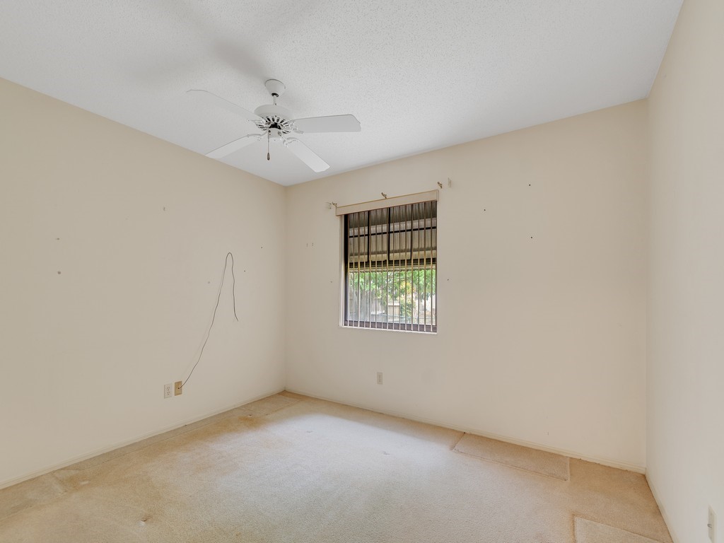 717 Doctor Avenue Sebastian, FL 32958 - Photo 25 of 33 an empty room with a window and a ceiling fan