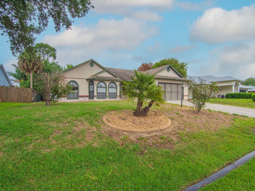 717 Doctor Avenue Sebastian, FL 32958 - Photo 6 of 33 a front view of a house with a yard and trees