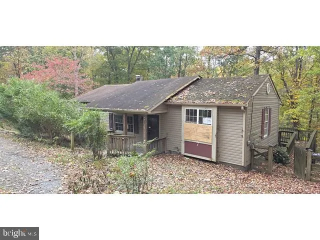 a aerial view of a house with a yard table and chairs