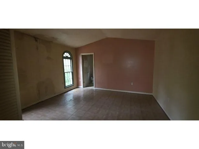 a view of an empty room and wooden floor