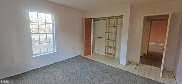 an empty room that has a glass door and shower