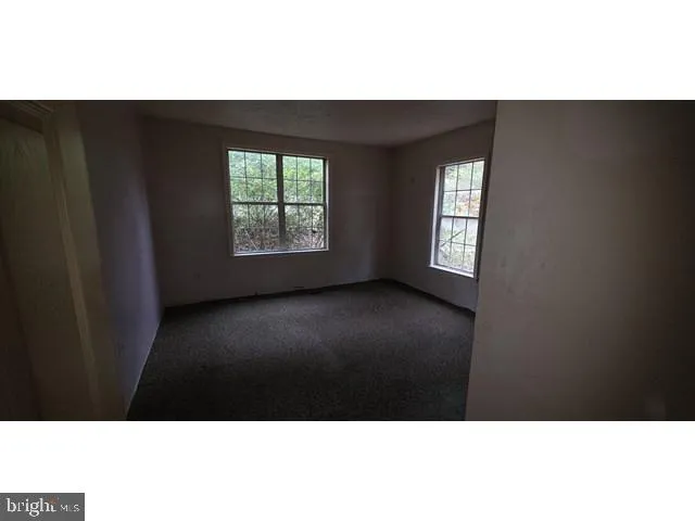 a view of an empty room and wooden floor