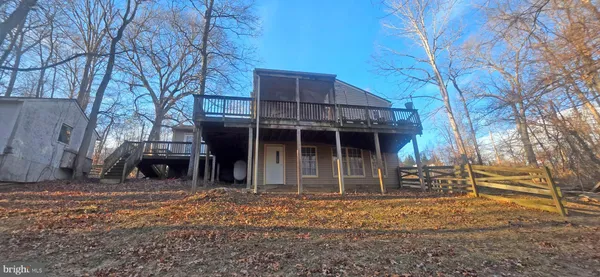 a view of a house with a yard and wooden fence