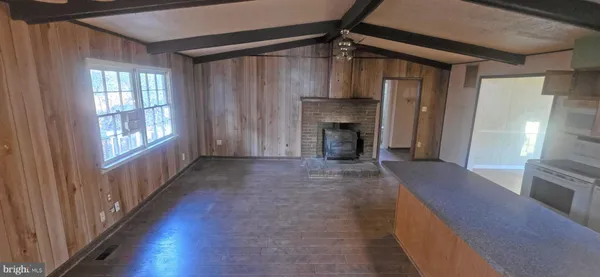 a view of a livingroom with a fireplace and window