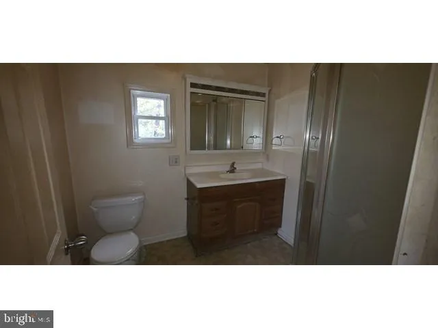 a bathroom with a sink a toilet and mirror