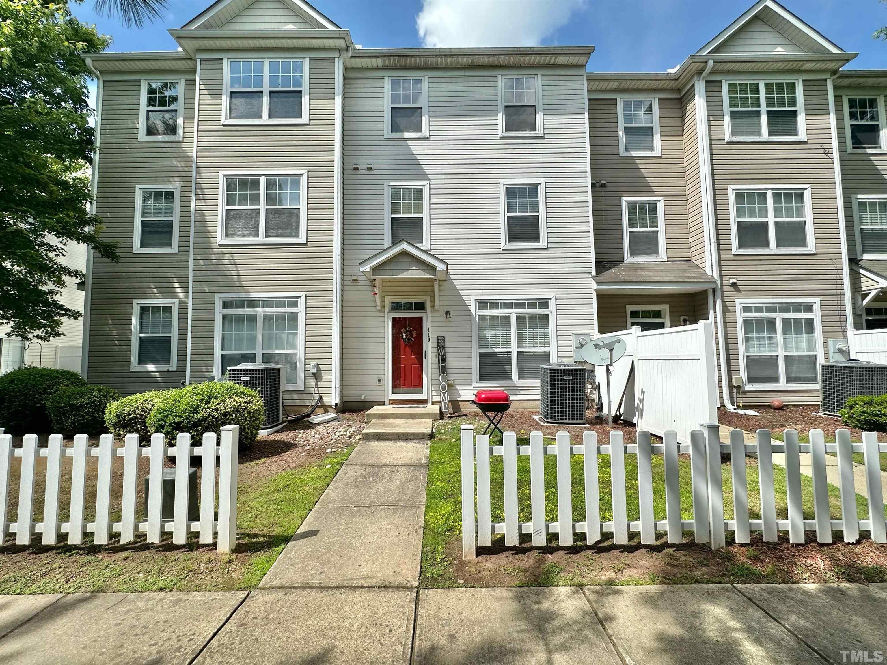 330 Gilman Lane, Unit 110 Raleigh, NC 27610 - Photo 1 of 13 a front view of a house with a fence