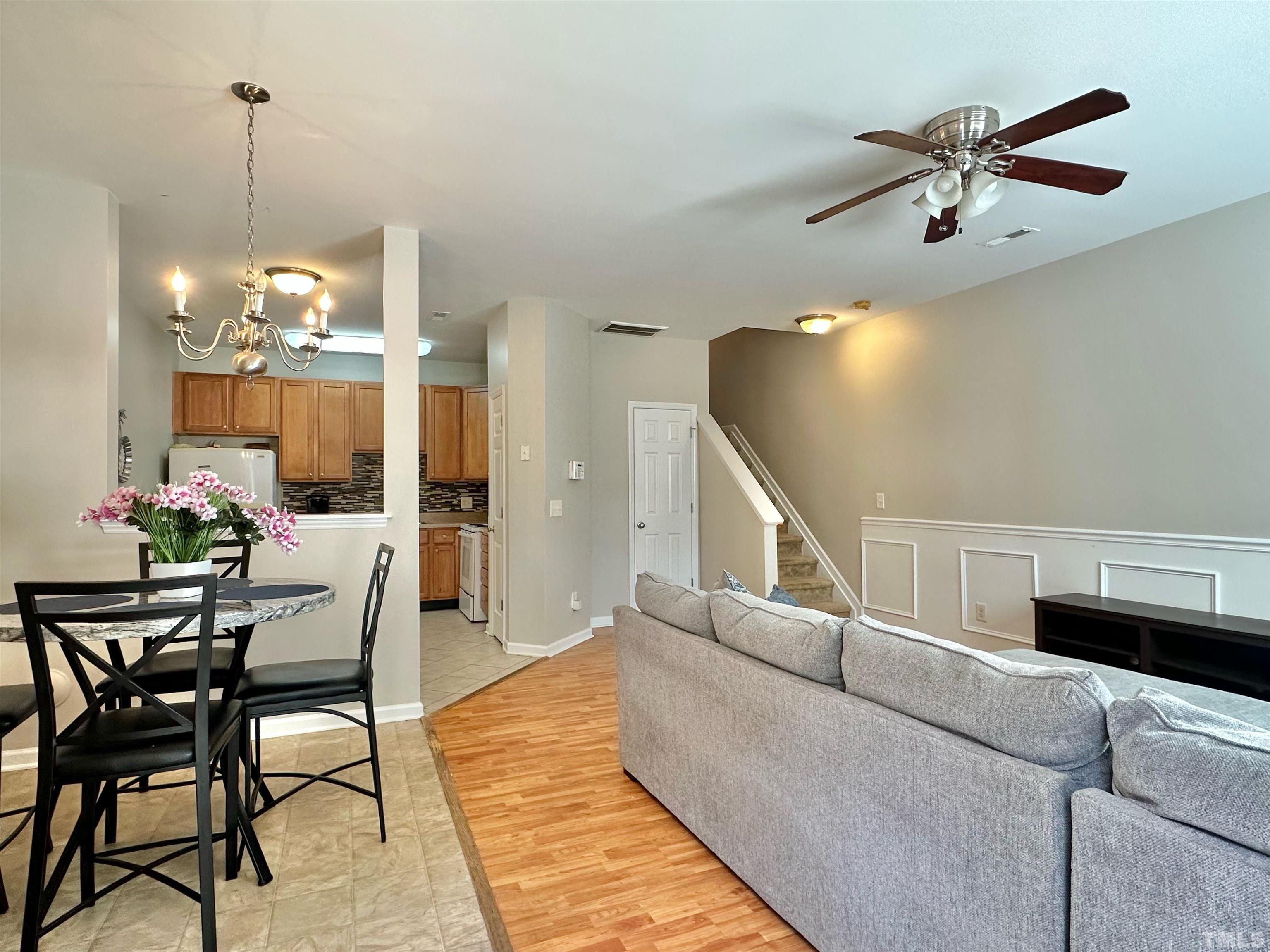 330 Gilman Lane, Unit 110 Raleigh, NC 27610 - Photo 2 of 13 a living room with furniture and a chandelier