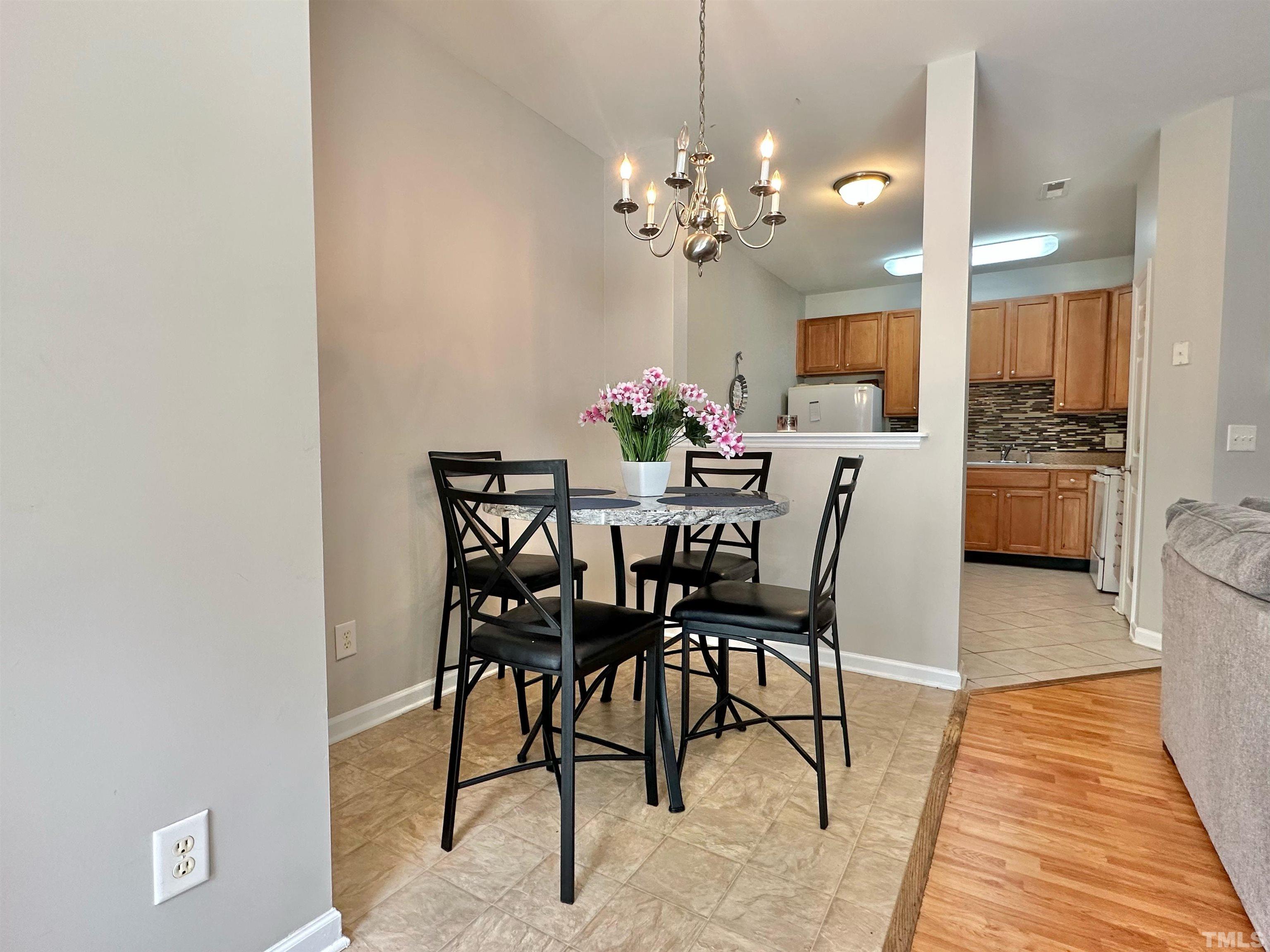 330 Gilman Lane, Unit 110 Raleigh, NC 27610 - Photo 3 of 13 a view of a dining room with furniture and chandelier