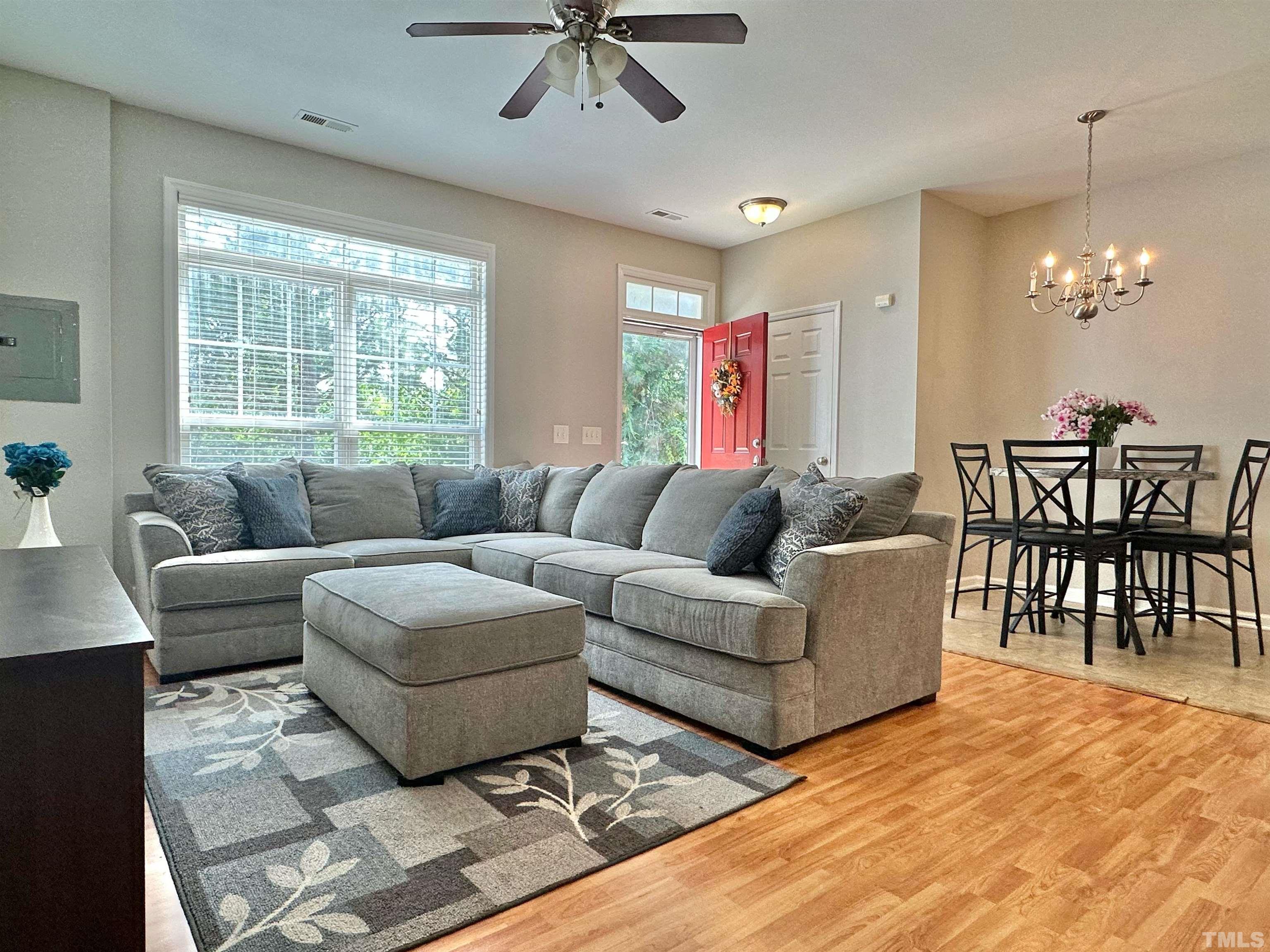 330 Gilman Lane, Unit 110 Raleigh, NC 27610 - Photo 4 of 13 a living room with furniture a dining table and a window