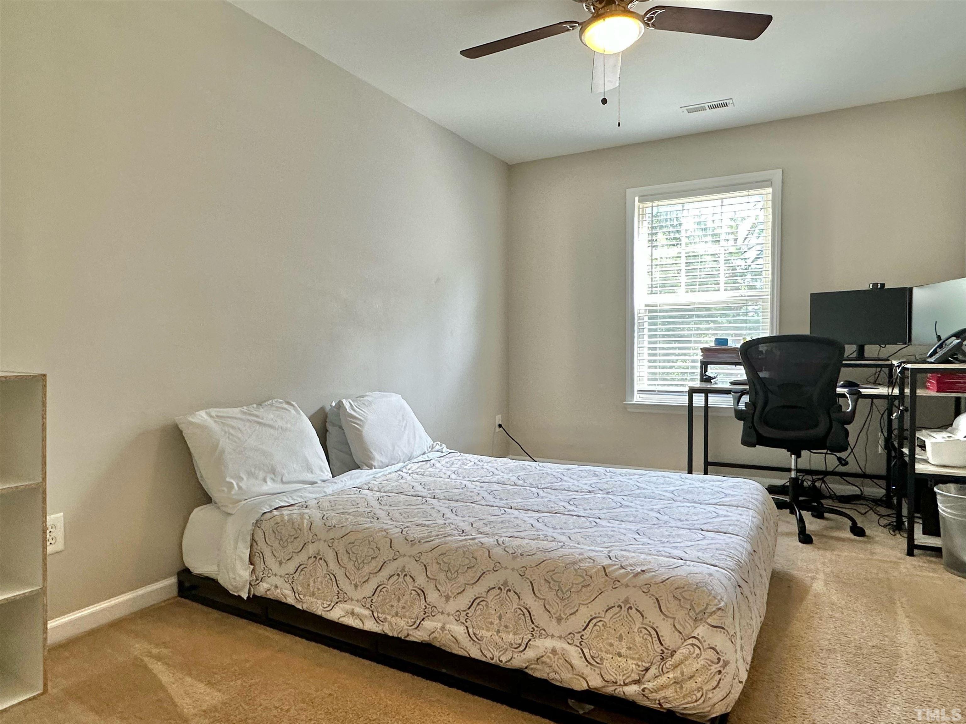 330 Gilman Lane, Unit 110 Raleigh, NC 27610 - Photo 7 of 13 a bedroom with a bed and a window