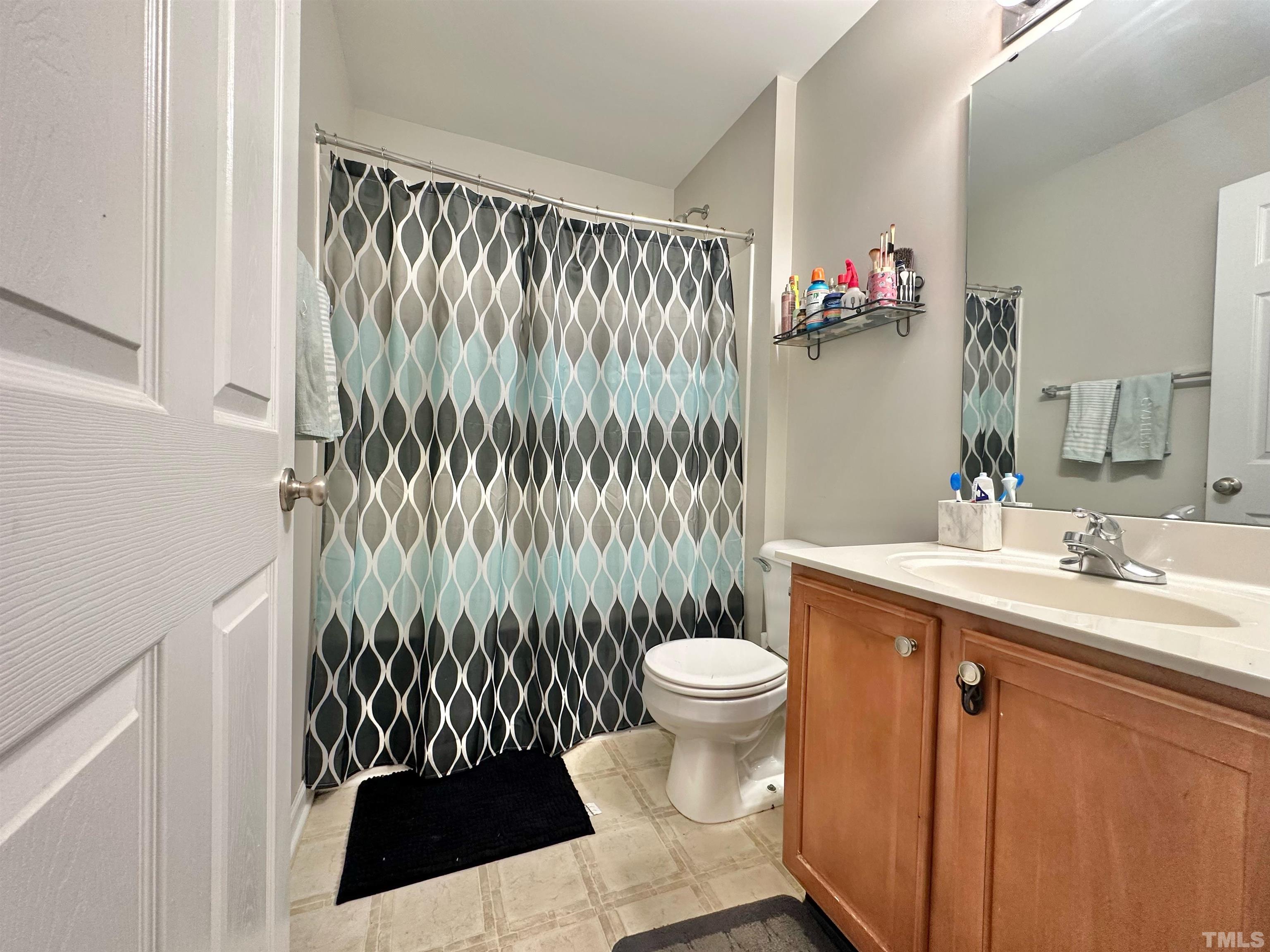 330 Gilman Lane, Unit 110 Raleigh, NC 27610 - Photo 8 of 13 a bathroom with a sink toilet and a mirror