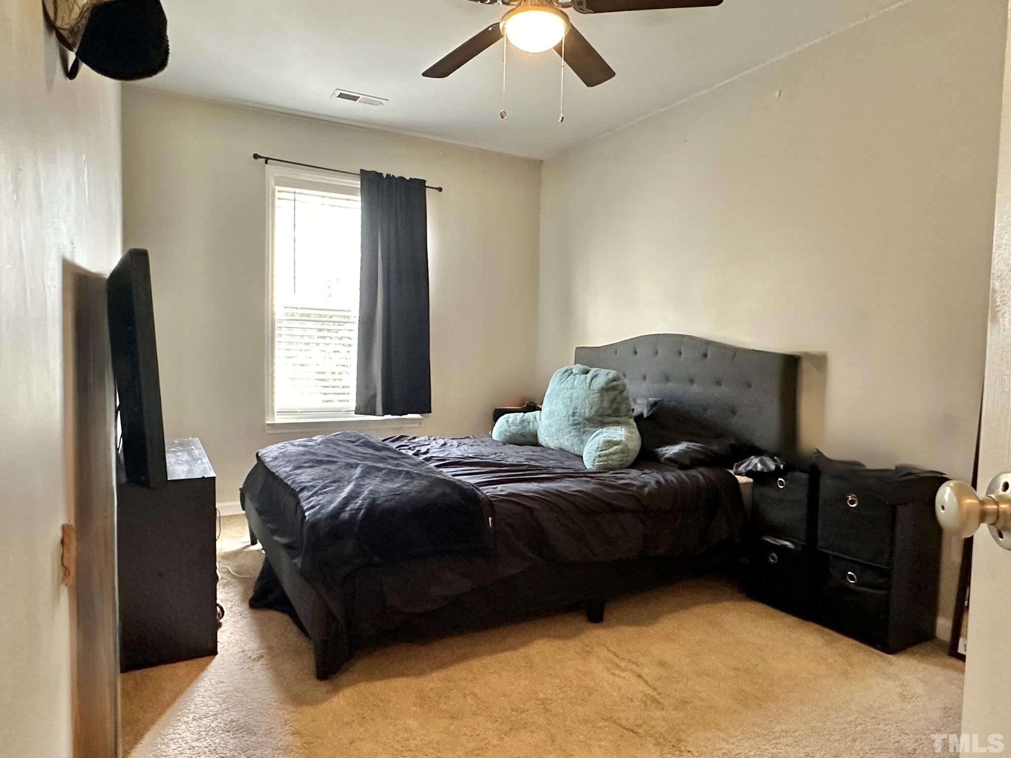 330 Gilman Lane, Unit 110 Raleigh, NC 27610 - Photo 9 of 13 a bedroom with a bed and a television