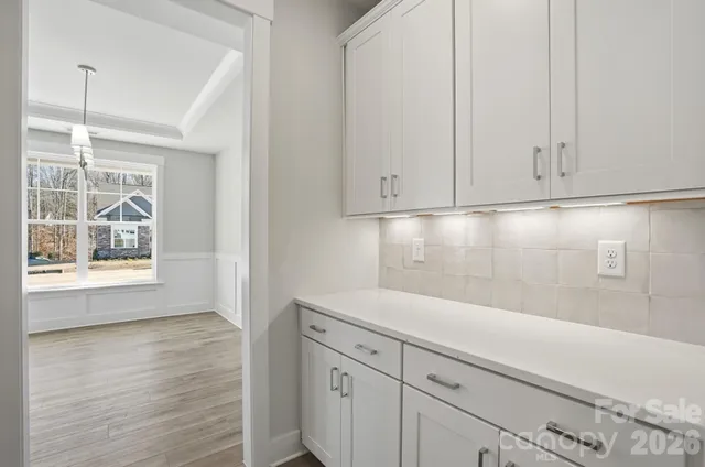 a view of a kitchen with white cabinets