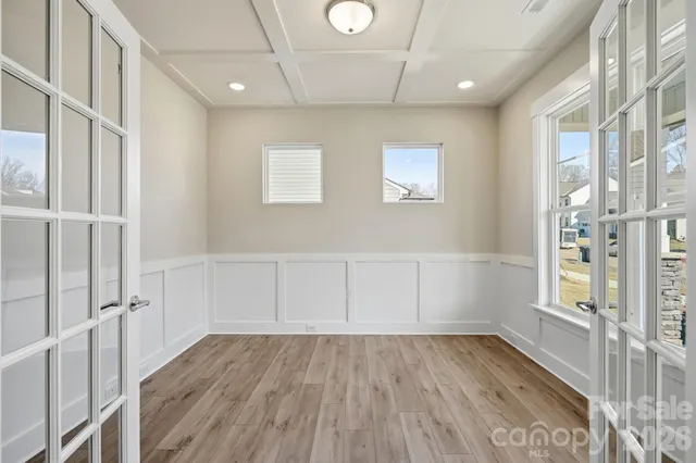 wooden floor in an empty room with a window