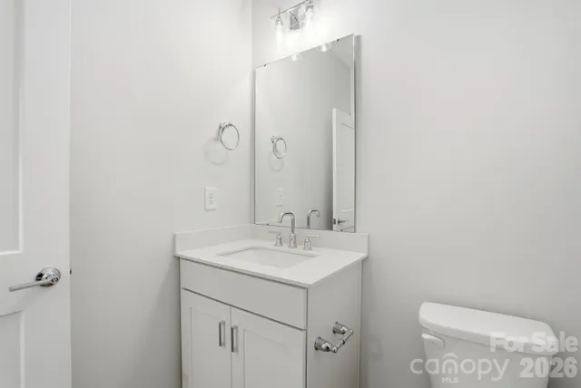 a bathroom with a sink a toilet and mirror