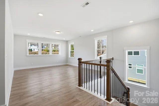 a view of a hallway with windows and stairs
