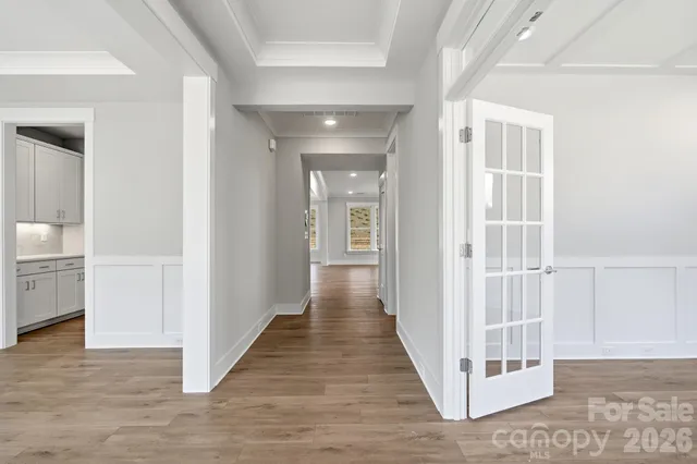 a view of a hallway with a white walls and stairs