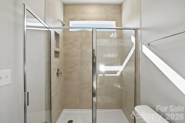 a bathroom with a glass shower door