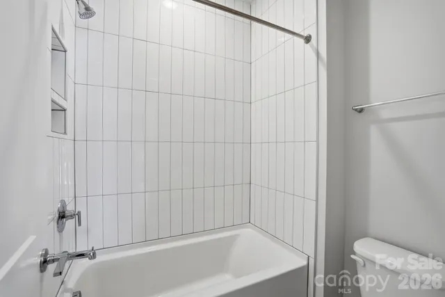 a bathroom with a white bath tub and shower