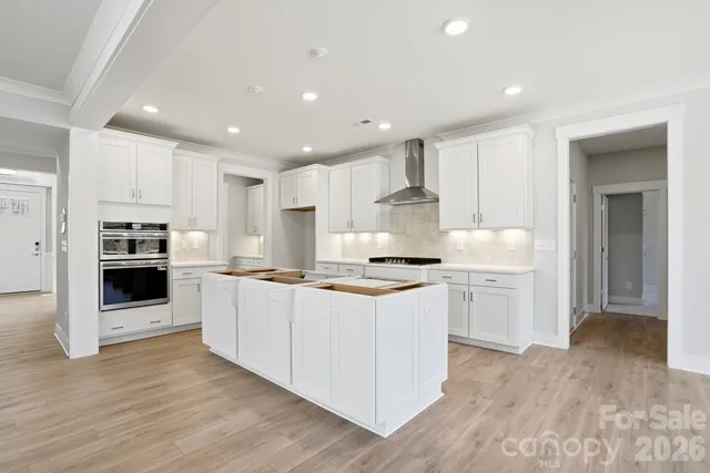 a kitchen with stainless steel appliances granite countertop a stove and a sink