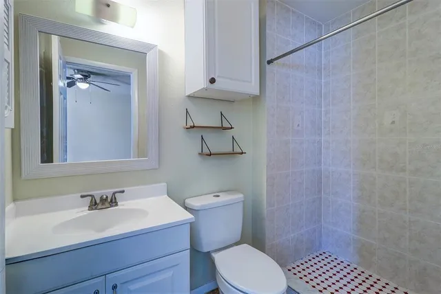 a bathroom with a sink a toilet and shower