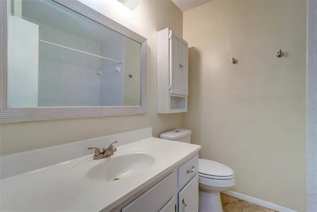 a bathroom with a sink toilet and vanity