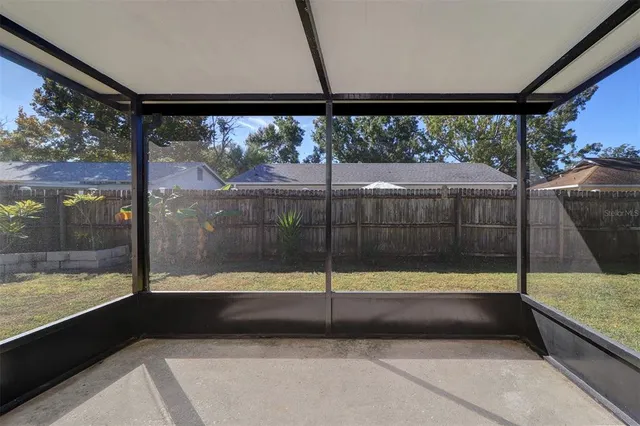 a view of a glass door with a floor to ceiling window next to a yard