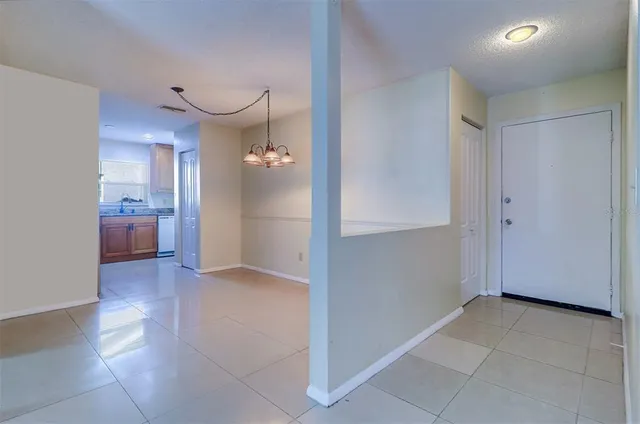 an empty room with a kitchen and a sink
