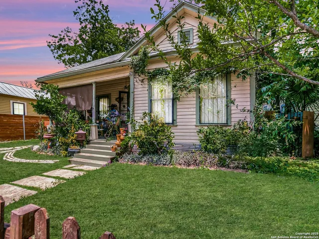 a view of a house with a yard and plants