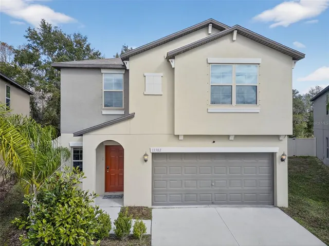 a front view of a house with garage