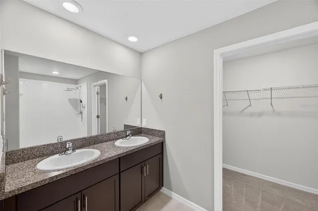 a bathroom with a double vanity sink and a mirror
