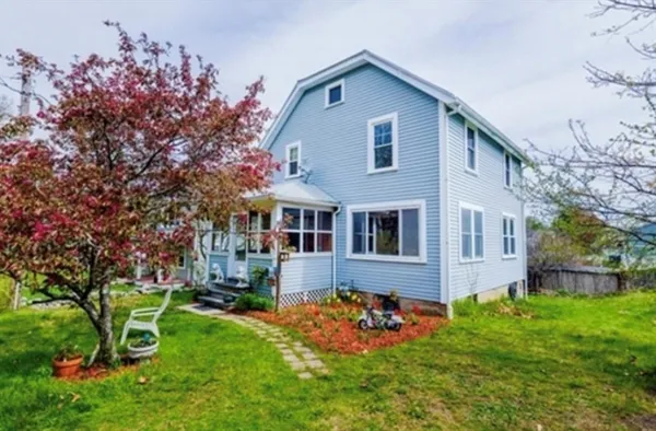 a front view of house with yard and green space