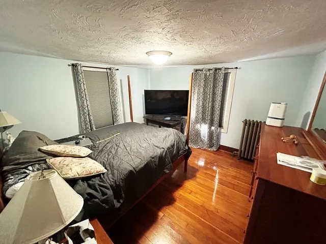 a bedroom with a bed and flat screen tv