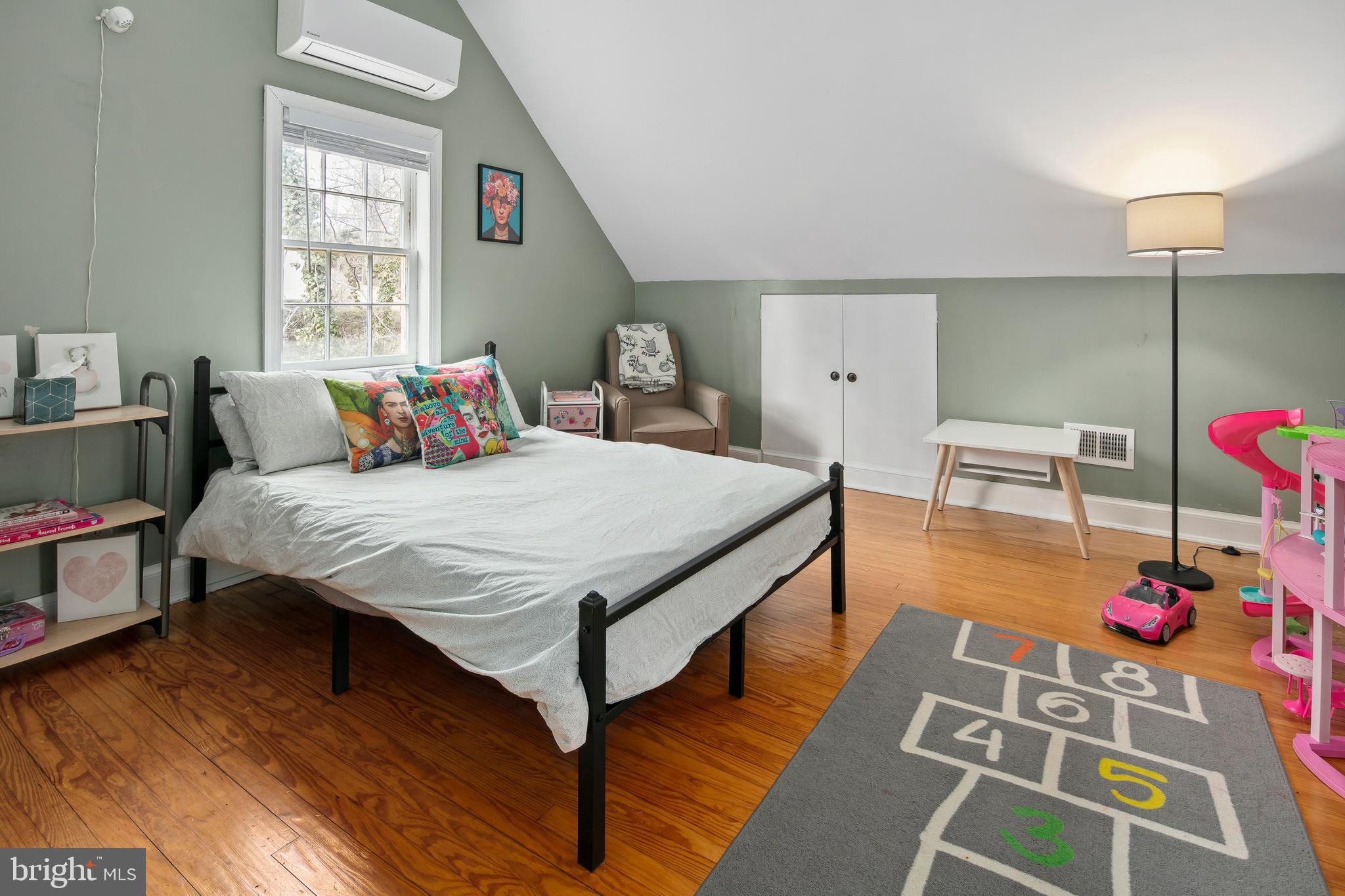 1212 Dale Drive Silver Spring, MD 20910 - Photo 30 of 59 a bedroom with a bed and a table with wooden floor